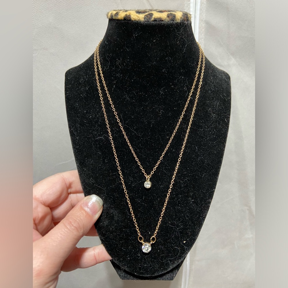 Gold Tone Layer Necklace With Solitary Rhinestone on each Layer.
